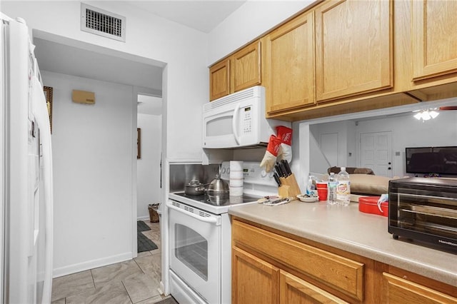 kitchen featuring light countertops, white appliances, visible vents, and a toaster