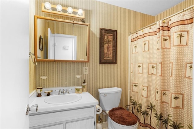 full bathroom with toilet, wallpapered walls, curtained shower, and vanity