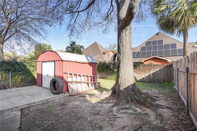 view of yard with a shed, an outdoor structure, and a fenced backyard