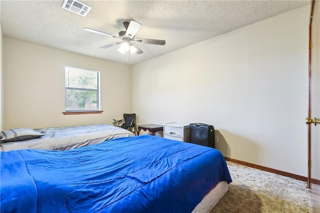 bedroom featuring baseboards, visible vents, ceiling fan, a textured ceiling, and carpet floors