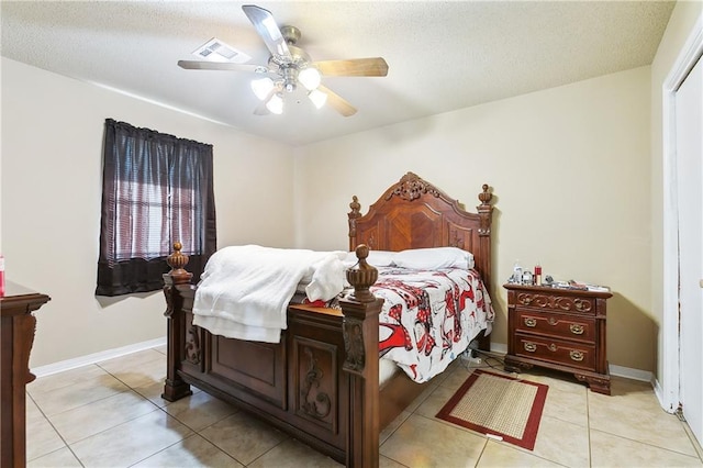 bedroom featuring light tile patterned floors, baseboards, visible vents, and ceiling fan