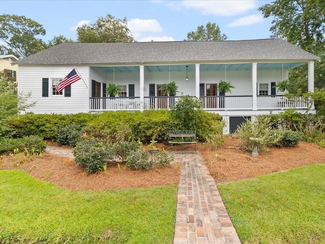 303 Lamarque St, Mandeville, LA 70448 - view of front of property with a front yard, a shingled roof, and covered porch