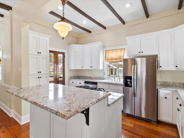 kitchen with a center island, white cabinetry, and stainless steel fridge with ice dispenser