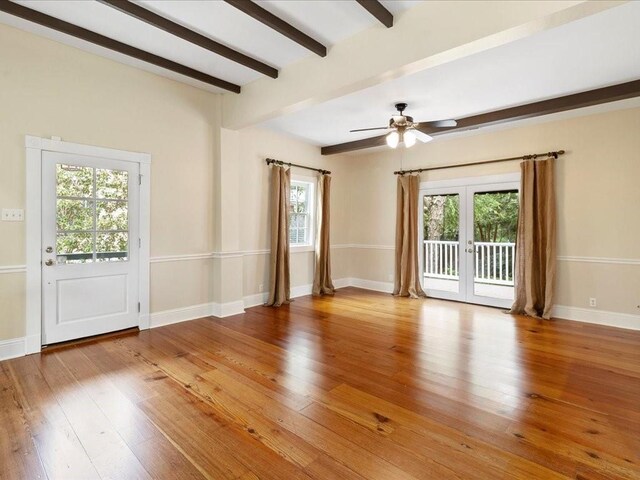 303 Lamarque St, Mandeville, LA 70448 - spare room with beamed ceiling, healthy amount of natural light, hardwood / wood-style flooring, ceiling fan, and baseboards