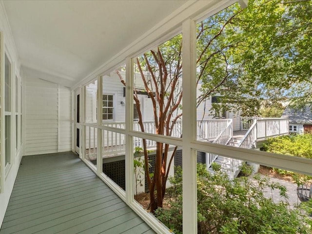 unfurnished sunroom featuring vaulted ceiling