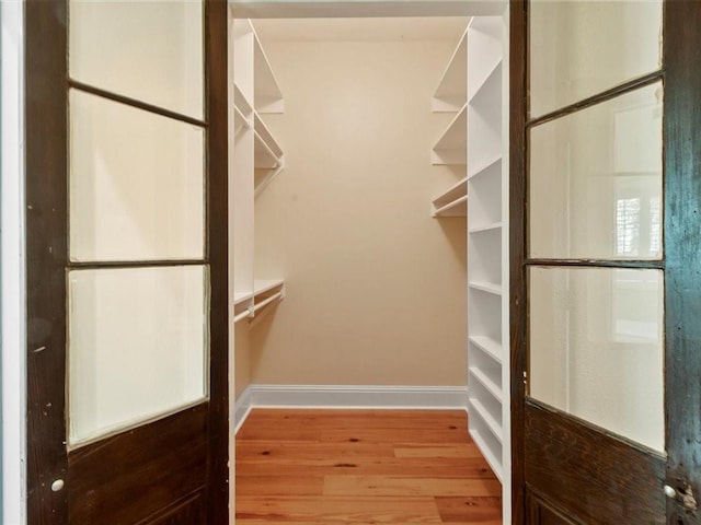 303 Lamarque St, Mandeville, LA 70448 - walk in closet with wood finished floors