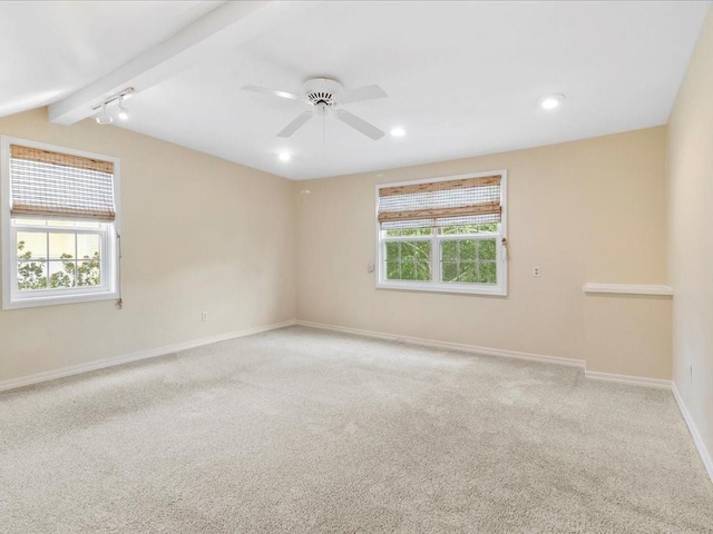 unfurnished room with light carpet, a ceiling fan, baseboards, and a wealth of natural light