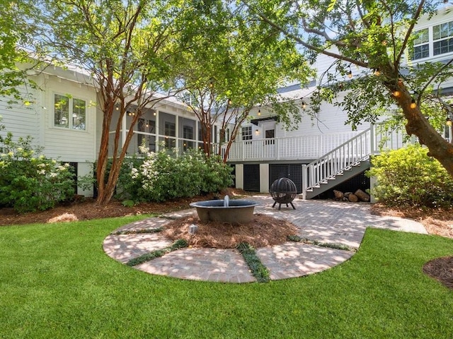 view of yard featuring a patio, stairway, and a wooden deck