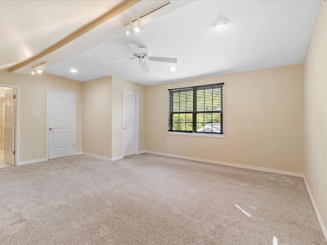 303 Lamarque St, Mandeville, LA 70448 - unfurnished room featuring carpet flooring, baseboards, a ceiling fan, rail lighting, and beamed ceiling