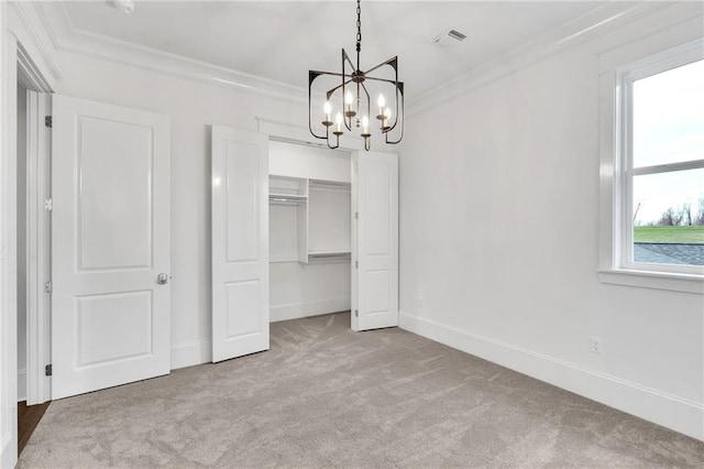 unfurnished bedroom with crown molding, visible vents, baseboards, carpet, and an inviting chandelier