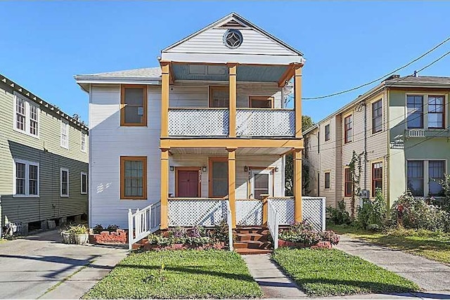 view of front of property with a porch and a balcony