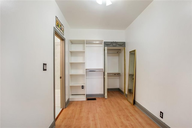 unfurnished bedroom featuring visible vents, light wood-style flooring, and baseboards