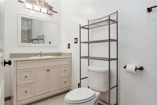 bathroom featuring vanity, tile patterned flooring, and toilet