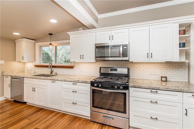 kitchen featuring stainless steel appliances, a sink, white cabinets, light wood-type flooring, and open shelves