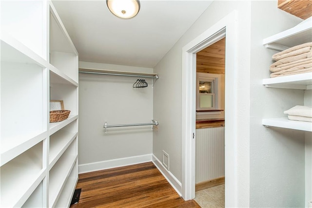 spacious closet with wood finished floors and visible vents