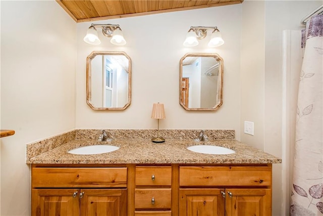 bathroom featuring double vanity, wooden ceiling, and a sink