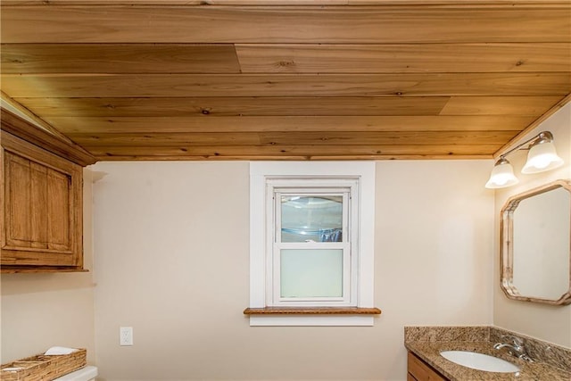 bathroom with vanity and wood ceiling