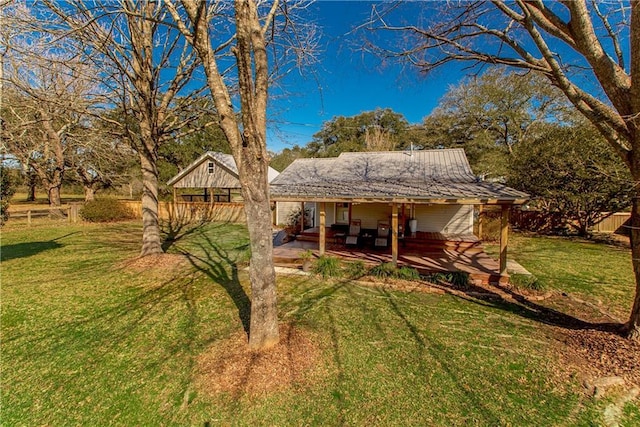 back of house featuring a patio area, fence, and a lawn