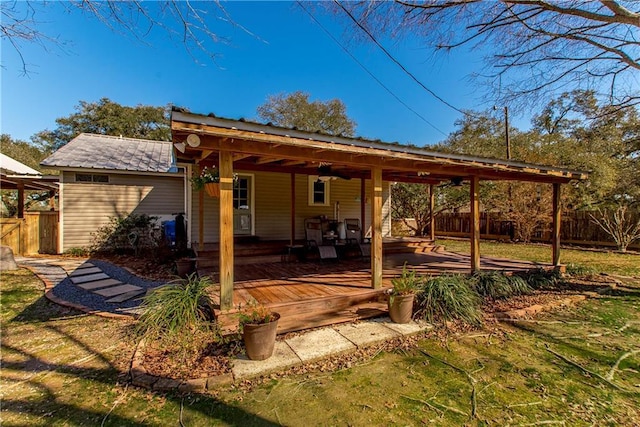 view of patio / terrace featuring an attached carport, fence, and a deck