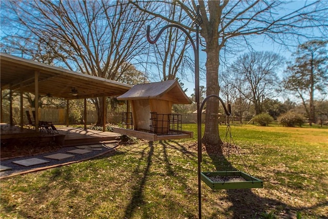 view of yard with fence and ceiling fan