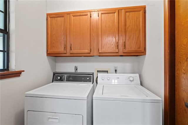 laundry room featuring cabinet space and washer and clothes dryer