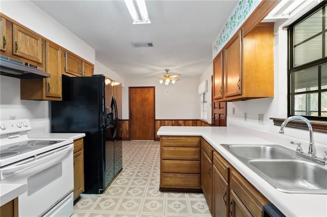 kitchen with visible vents, electric range, wainscoting, a sink, and under cabinet range hood