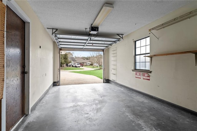 garage with baseboards and a garage door opener