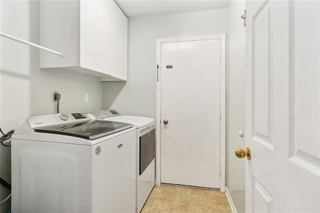 clothes washing area with cabinet space and washing machine and clothes dryer