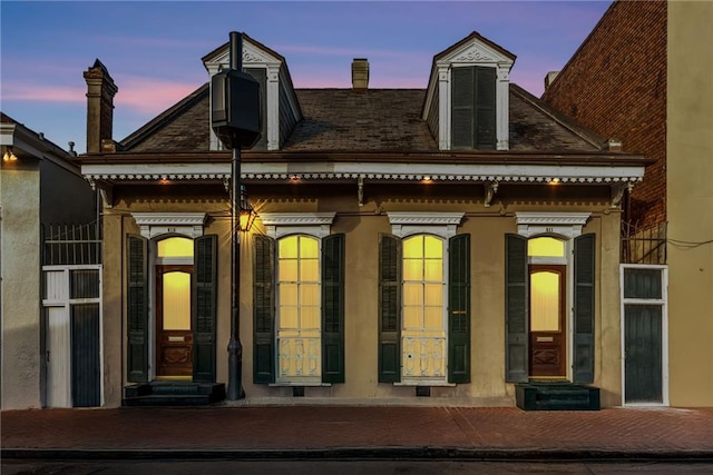 view of back of house at dusk