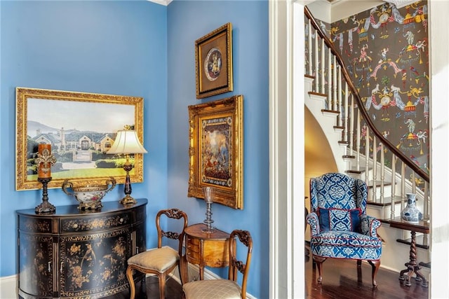 sitting room featuring stairway, wood finished floors, and baseboards