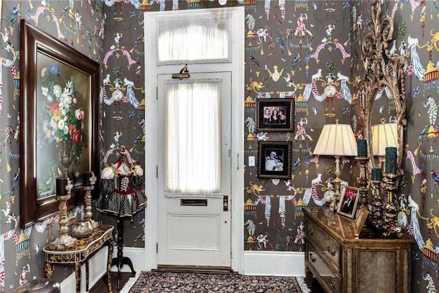 entrance foyer with wallpapered walls and baseboards