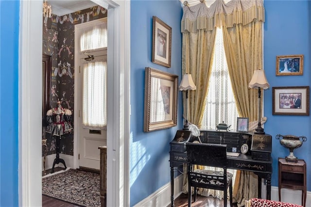 sitting room with baseboards, wood finished floors, and wallpapered walls