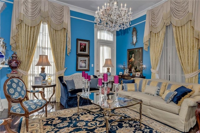 living area featuring an inviting chandelier, crown molding, and wood finished floors