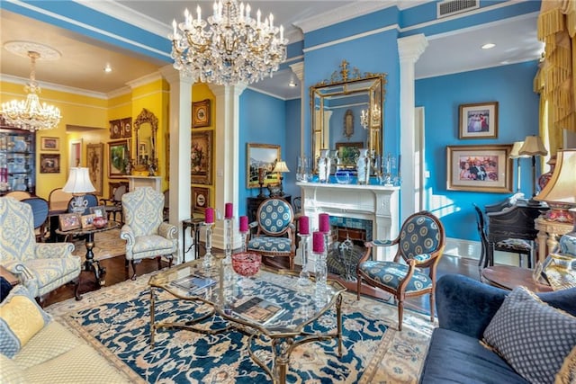 living room with a tile fireplace, visible vents, a notable chandelier, and ornate columns