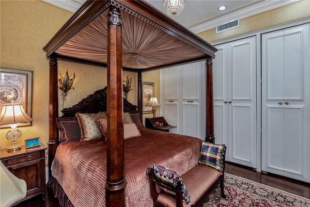 bedroom with ornamental molding and visible vents