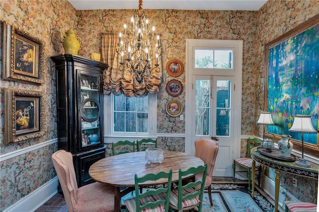 dining space with wallpapered walls, baseboards, brick floor, and a notable chandelier