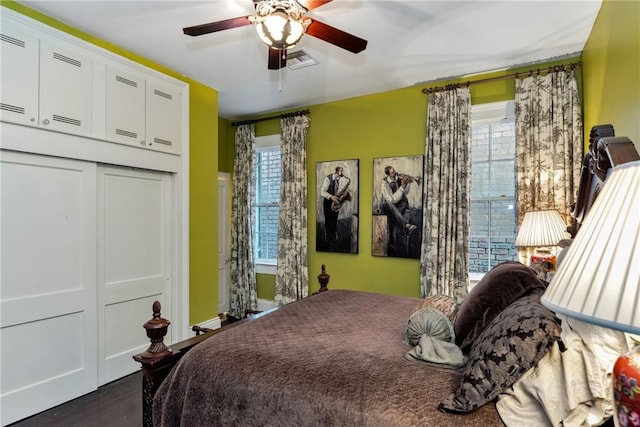 bedroom featuring multiple windows, a closet, visible vents, and a ceiling fan