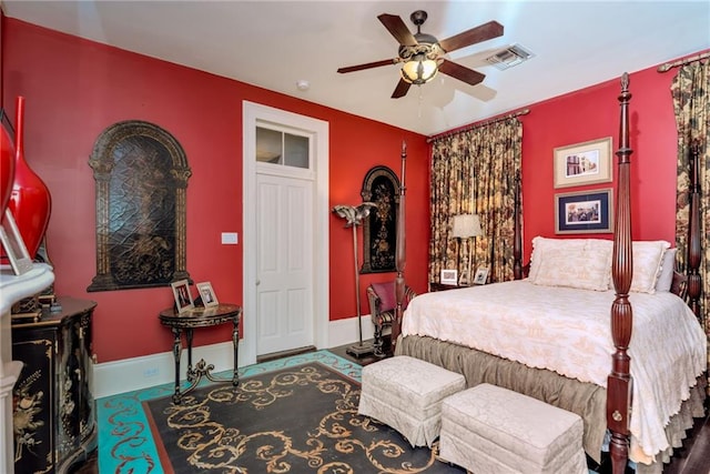 bedroom featuring baseboards, visible vents, and ceiling fan