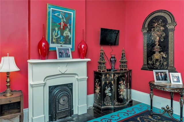 living room with a fireplace, wood finished floors, and baseboards