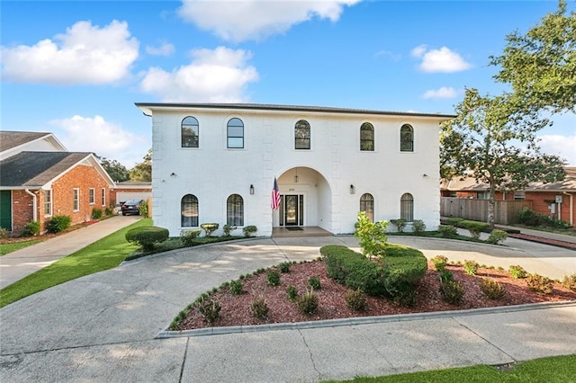 view of front of property with driveway and fence