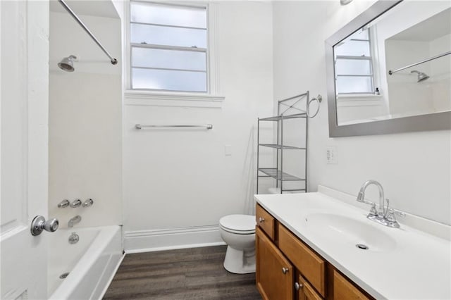 bathroom featuring wood finished floors, a healthy amount of sunlight, toilet, and shower / bathtub combination