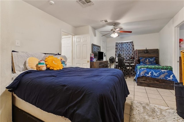 bedroom with ceiling fan, light tile patterned flooring, and visible vents