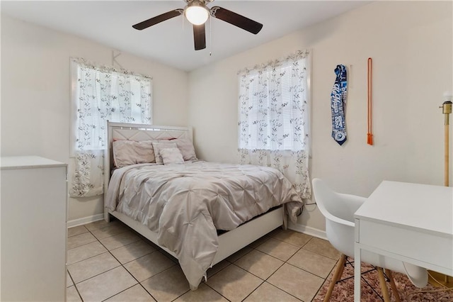 bedroom with baseboards, a ceiling fan, and light tile patterned flooring