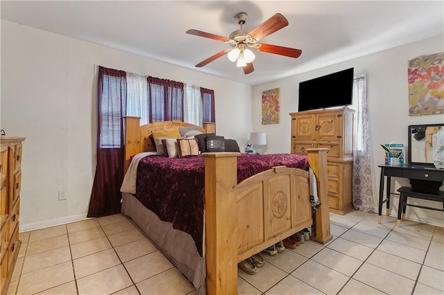 bedroom with light tile patterned floors, ceiling fan, and baseboards