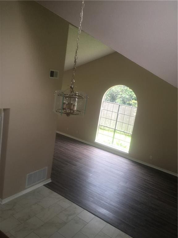 interior space with marble finish floor, baseboards, visible vents, and a chandelier