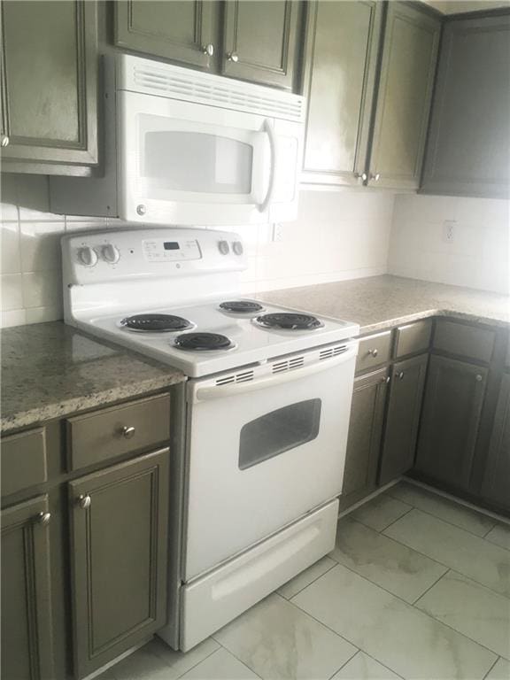 kitchen with white appliances and backsplash