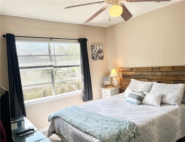 bedroom featuring a textured ceiling and ceiling fan