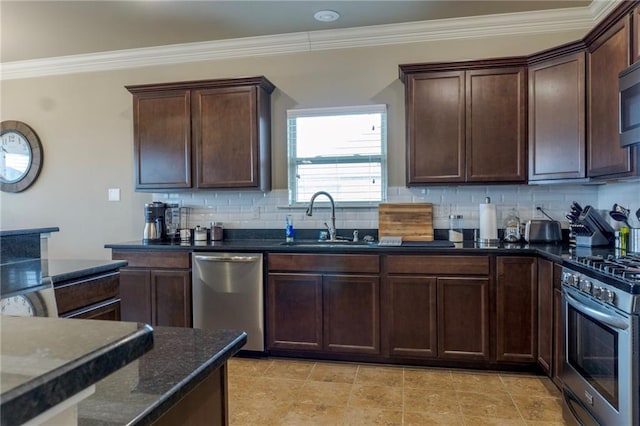 kitchen with stainless steel appliances, a sink, ornamental molding, decorative backsplash, and dark stone countertops