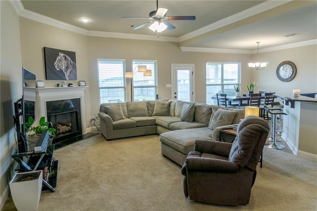 living area with carpet floors, crown molding, a premium fireplace, and a wealth of natural light