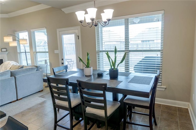 dining space with a notable chandelier, baseboards, crown molding, and tile patterned floors